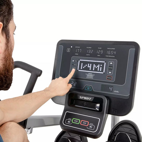 Person using a Spirit exercise bike console with digital display