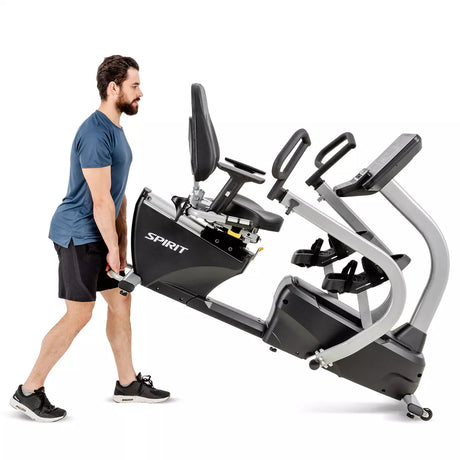 Man standing next to a Spirit exercise bike on a white background
