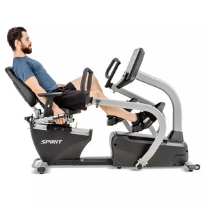 Man using a Spirit exercise bike on a white background