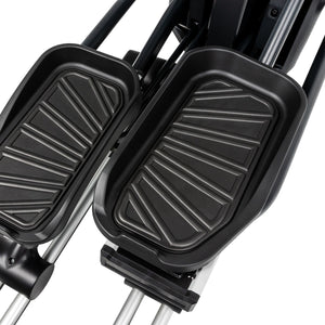 Black foot pedals on a stair climber machine