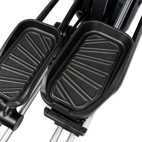 Black foot pedals on a stair climber machine