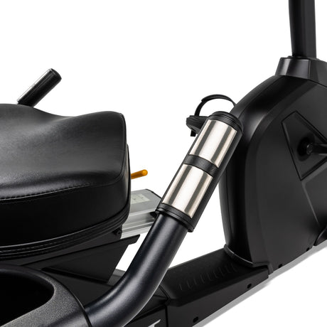 Close-up of a motorcycle with a black seat and silver exhaust pipe on a white background