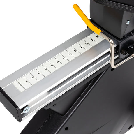 Close-up of a paper cutter with measurement scale on a white background