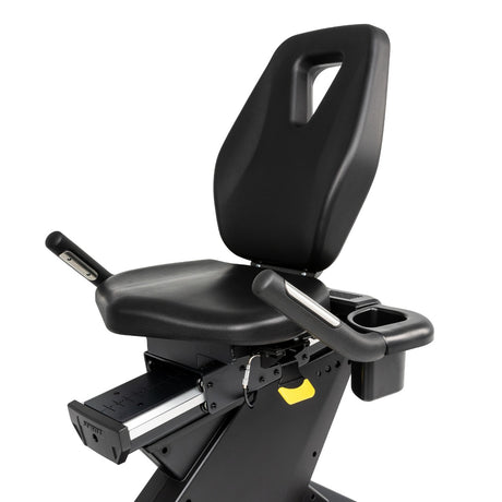 Black exercise bike seat with armrests on a white background