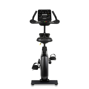 Black exercise bike with digital display on a white background