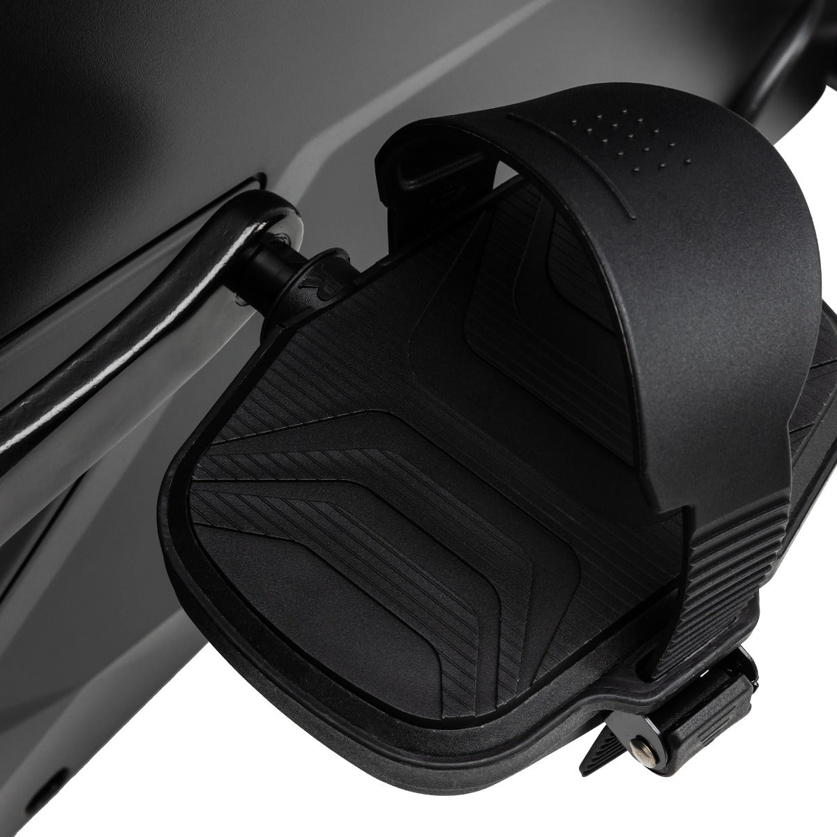 Close-up of a black motorcycle seat with a textured design on a white background