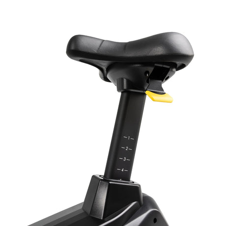 Black adjustable seat post with yellow button on a white background