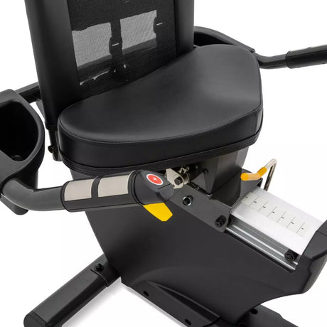 Close-up of a black exercise bike with a seat and handlebar on a white background