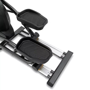Close-up of a black and silver elliptical machine on a white background