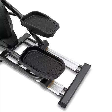Close-up of a black and silver elliptical machine on a white background
